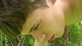 Dark-haired twink boy sucking that juicy dick outdoors